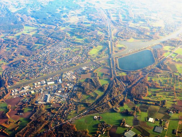 Luchtfoto van het Albertkanaal dat langs Ranst en Oelegem loopt, met een waterbekken en de snelweg